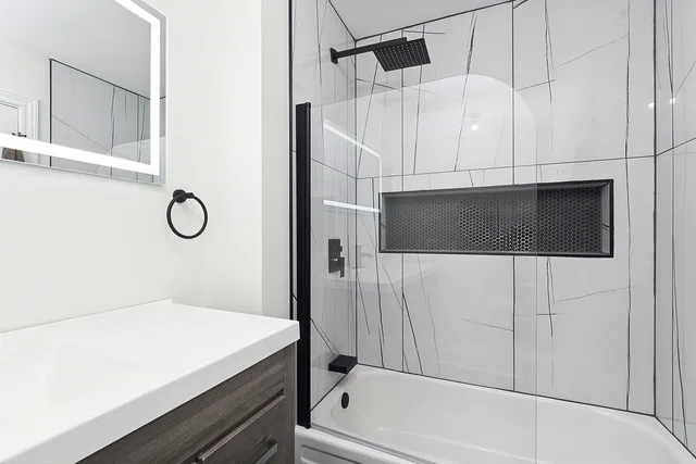 a bathroom with a bathtub and a shower