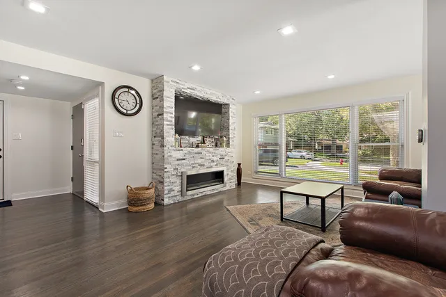 a living room with furniture a fireplace and a flat screen tv