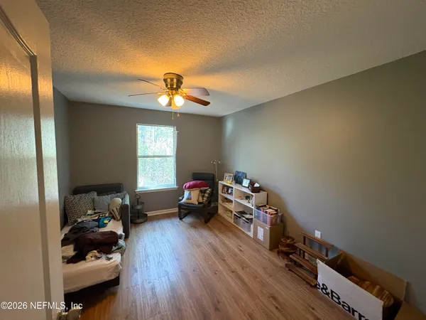 a bed room with a bed and a chair