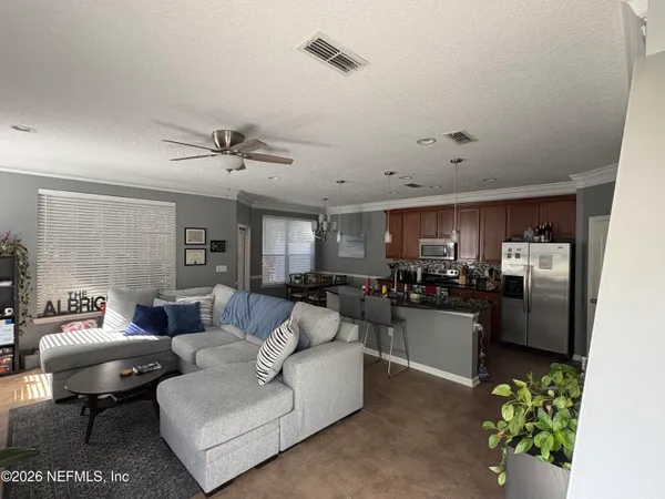 a living room with furniture and a chandelier