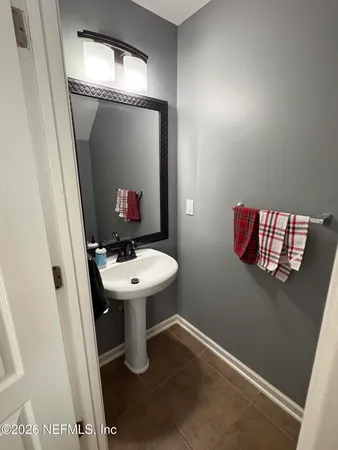 a bathroom with a sink toilet and mirror