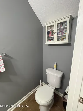a white toilet sitting next to a bathroom sink