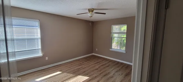 a bedroom with a bed and a flat tv screen on a dresser