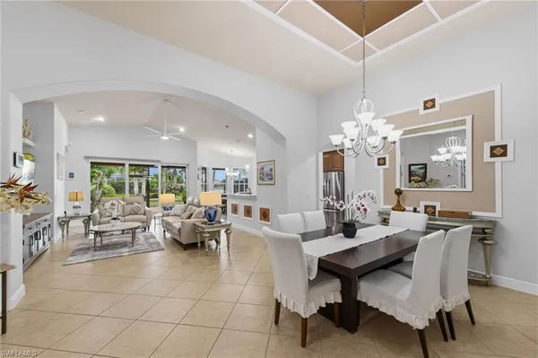 a living room with fireplace furniture and a chandelier