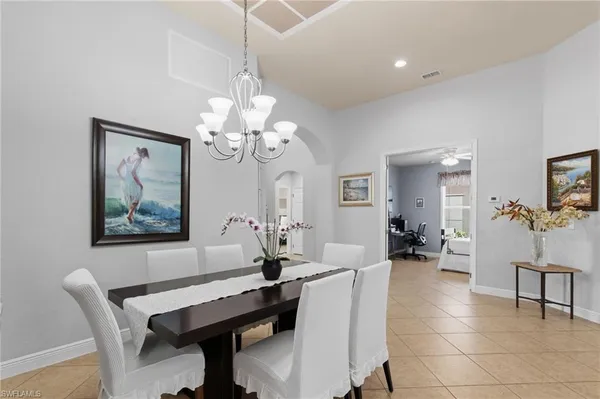 a view of a dining room with furniture and a chandelier