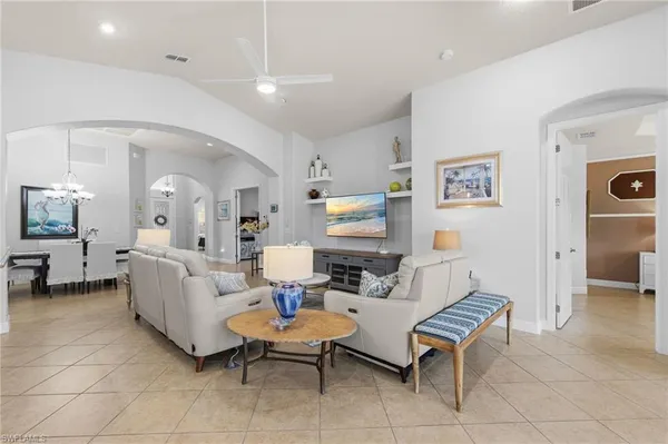 a living room with fireplace furniture and a table