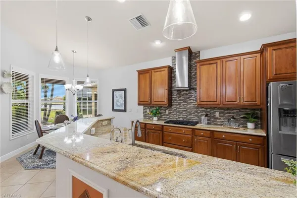 a kitchen with stainless steel appliances granite countertop sink stove and refrigerator