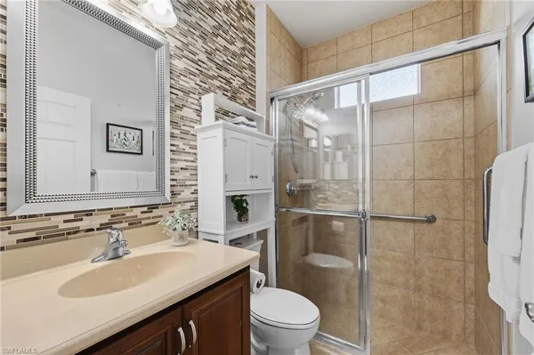a bathroom with a sink toilet and shower