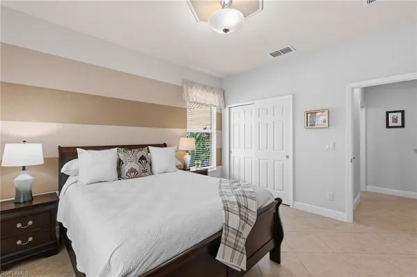 a bedroom with a bed and a lamp