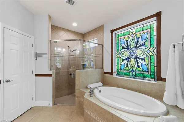 a bathroom with a bathtub and a shower