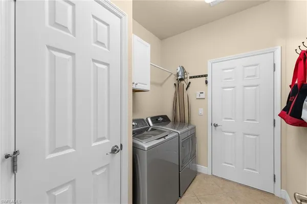 a view of a storage and utility room with a washer dryer