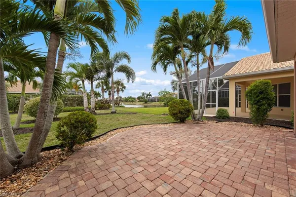 a view of a house with palm trees