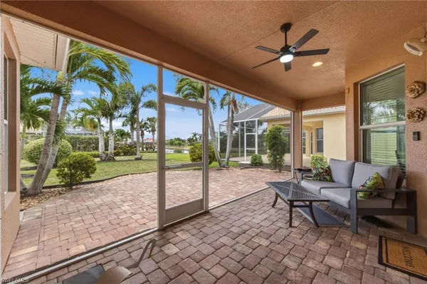 a living room with patio area and garden view