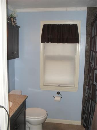 202 Shawmut Street Springfield, MA 01108 - Photo 17 of 30 a bathroom with a toilet a sink and a window