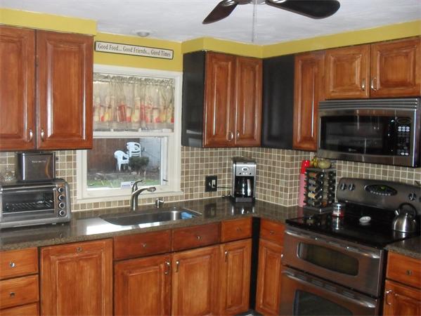 202 Shawmut Street Springfield, MA 01108 - Photo 3 of 30 a kitchen with stainless steel appliances granite countertop a sink a stove cabinets and a microwave oven