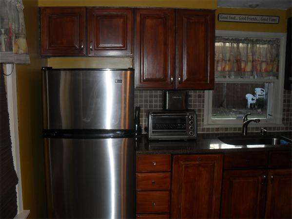 202 Shawmut Street Springfield, MA 01108 - Photo 6 of 30 a kitchen with stainless steel appliances granite countertop a refrigerator and a sink