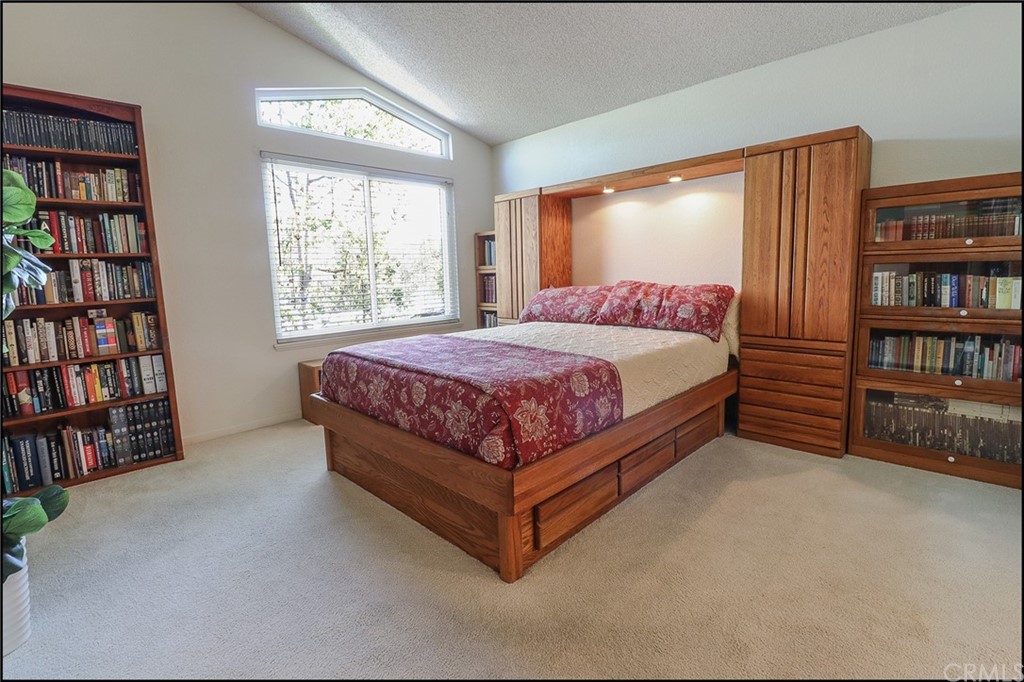 16 Pineoak Aliso Viejo, CA 92656 - Photo 11 of 24 a bed sitting in a bedroom next to a book shelf