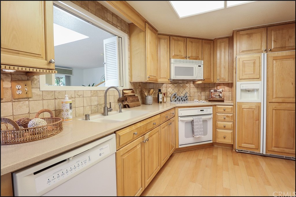 16 Pineoak Aliso Viejo, CA 92656 - Photo 8 of 24 a kitchen with granite countertop a sink stainless steel appliances and cabinets