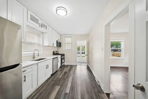 a kitchen with cabinets a sink and appliances