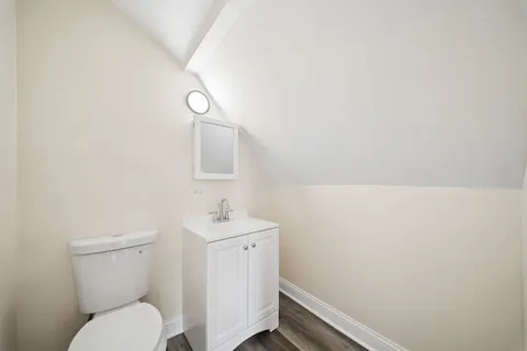 a bathroom with a toilet sink and vanity