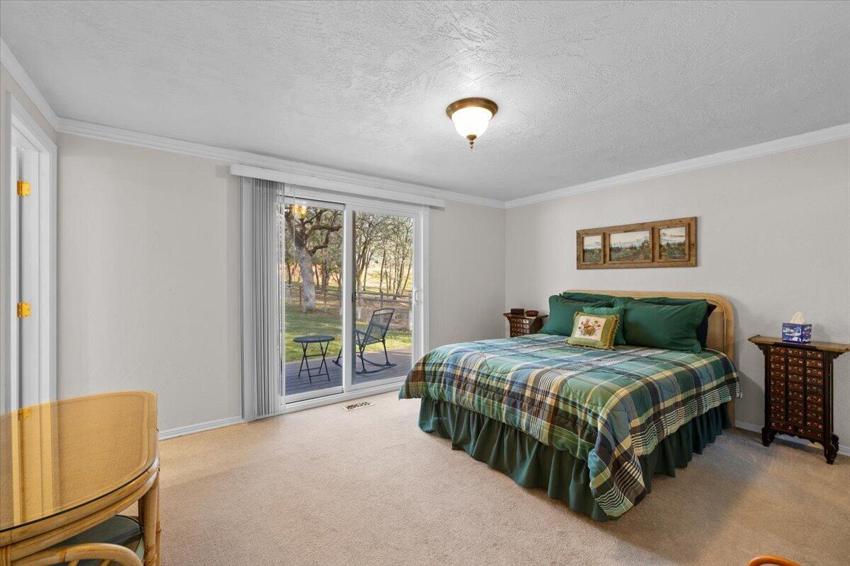 324 China Gulch Road Jacksonville, OR 97530 - Photo 30 of 45 a bedroom with a bed and a window