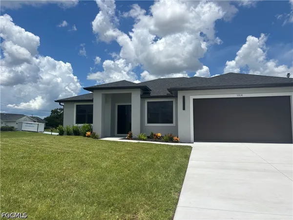 a front view of a house with a yard and garage