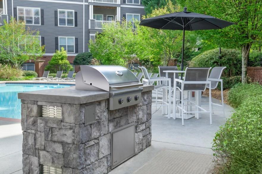 2500 Shallowford Road, Unit 44309 Atlanta, GA 30345 - Photo 14 of 20 a view of a patio with a table and chairs under an umbrella