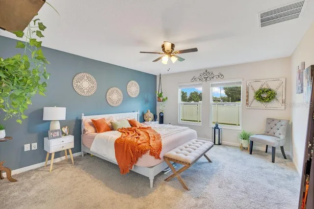 a bedroom with a bed and a table with chair