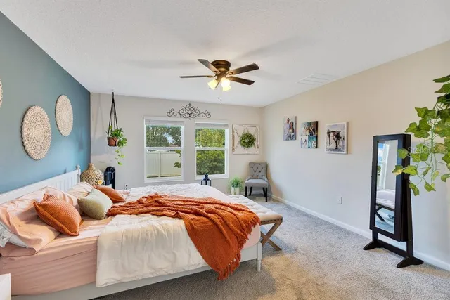 a bedroom with a bed and a chandelier