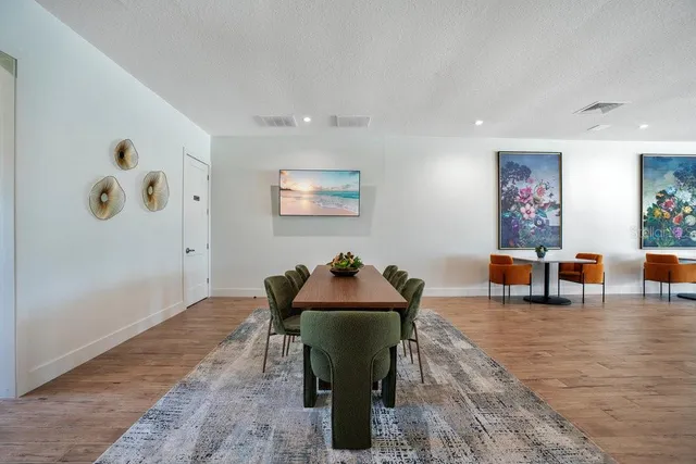 a living room with lots of furniture and wooden floor
