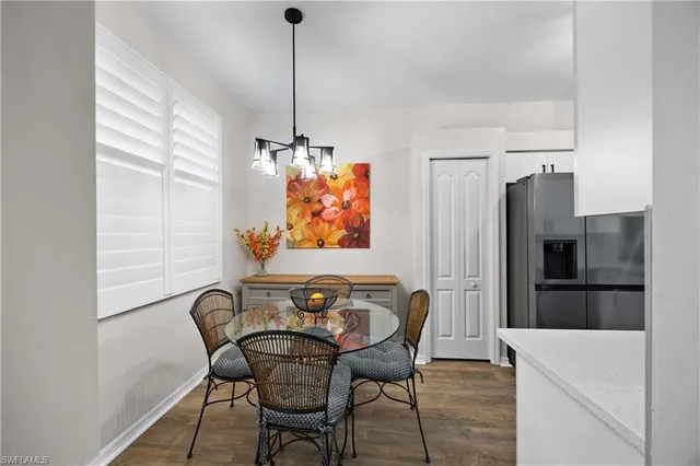 a view of a dining room with furniture and a chandelier