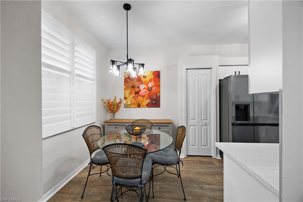 3760 Sawgrass Way, Unit 3514 Naples, FL 34112 - Photo 13 of 43 a view of a dining room with furniture and a chandelier