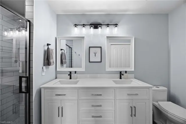 a bathroom with a double vanity sink and a mirror