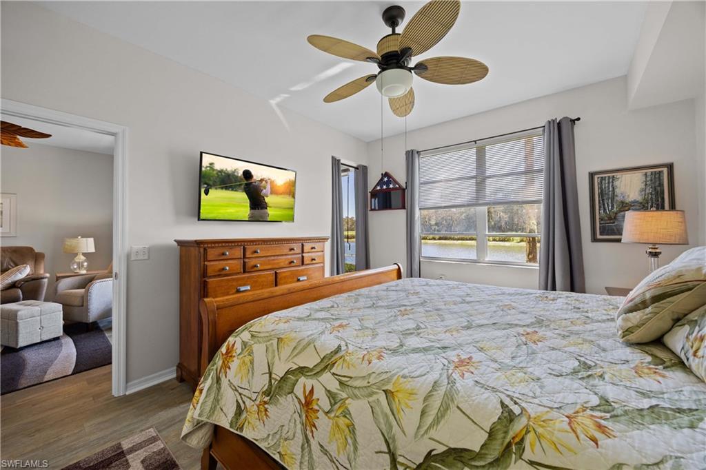 3760 Sawgrass Way, Unit 3514 Naples, FL 34112 - Photo 15 of 43 a bedroom with a bed and a flat tv screen on dresser