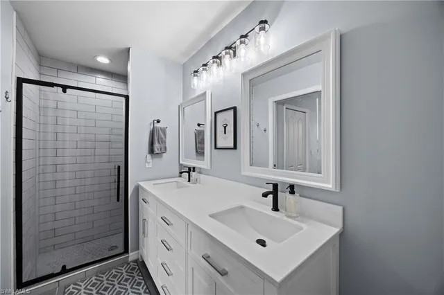 a bathroom with a sink a mirror and shower