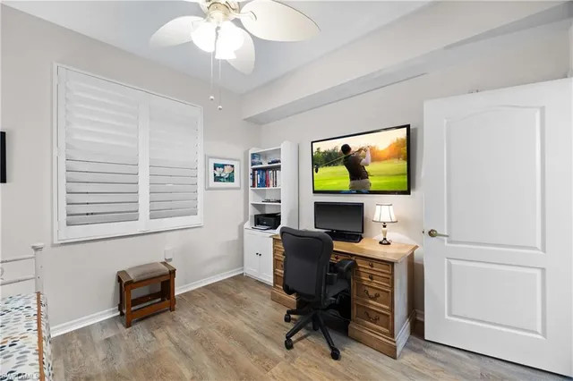 a view of a workspace with furniture and a window