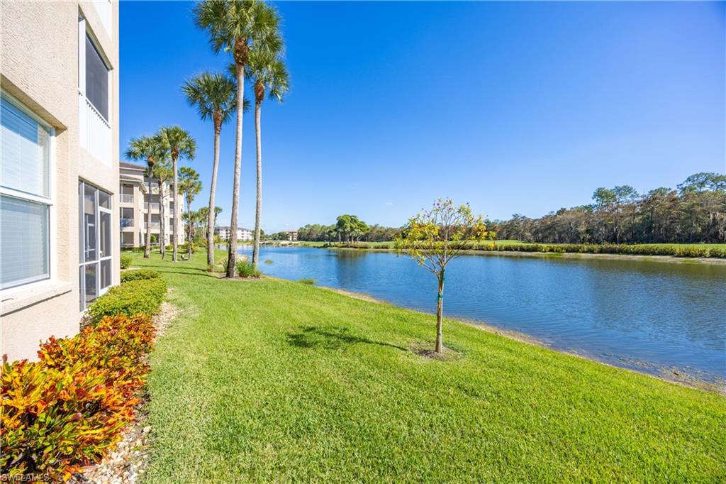 3760 Sawgrass Way, Unit 3514 Naples, FL 34112 - Photo 23 of 43 a view of a lake with houses in the back
