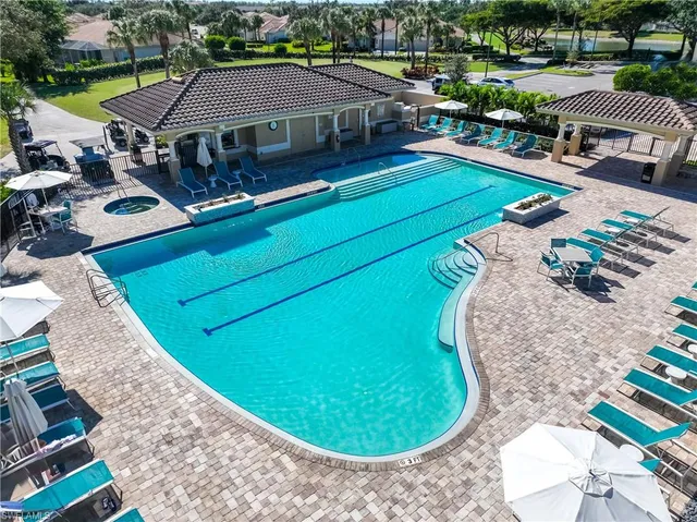 an aerial view of a house with a swimming pool patio and outdoor seating