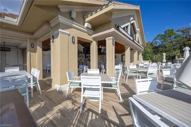 a view of a patio with table and chairs and potted plants