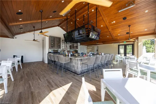 a living room with lots of furniture and wooden floors