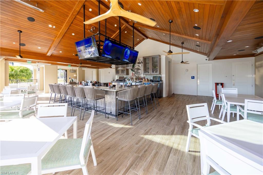 3760 Sawgrass Way, Unit 3514 Naples, FL 34112 - Photo 32 of 43 a view of a dining hall with many windows