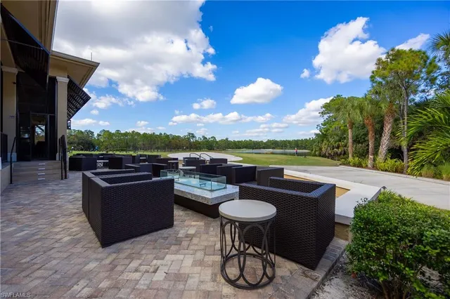 a view of a backyard with sitting area