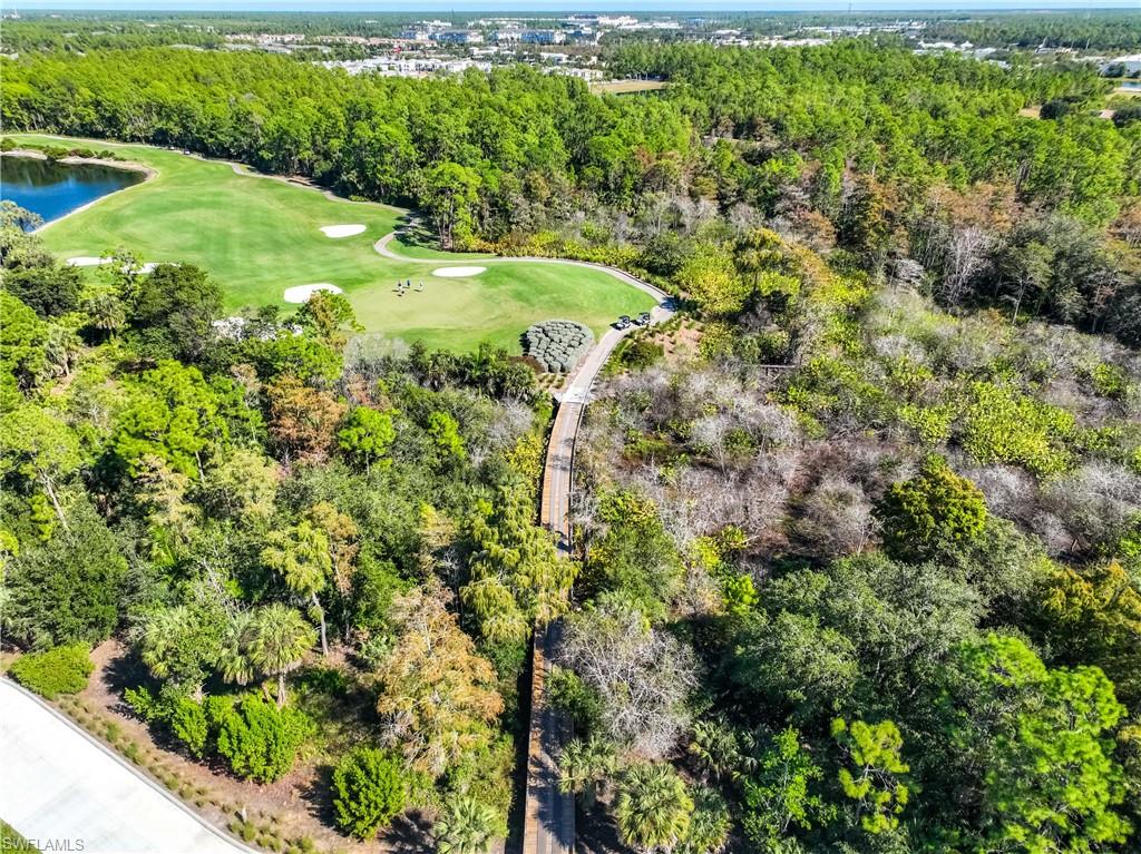 3760 Sawgrass Way, Unit 3514 Naples, FL 34112 - Photo 40 of 43 a view of a garden with a lake