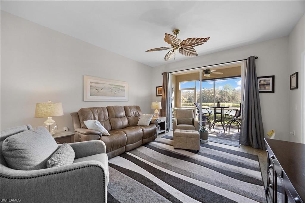 3760 Sawgrass Way, Unit 3514 Naples, FL 34112 - Photo 6 of 43 a living room with furniture and a large window