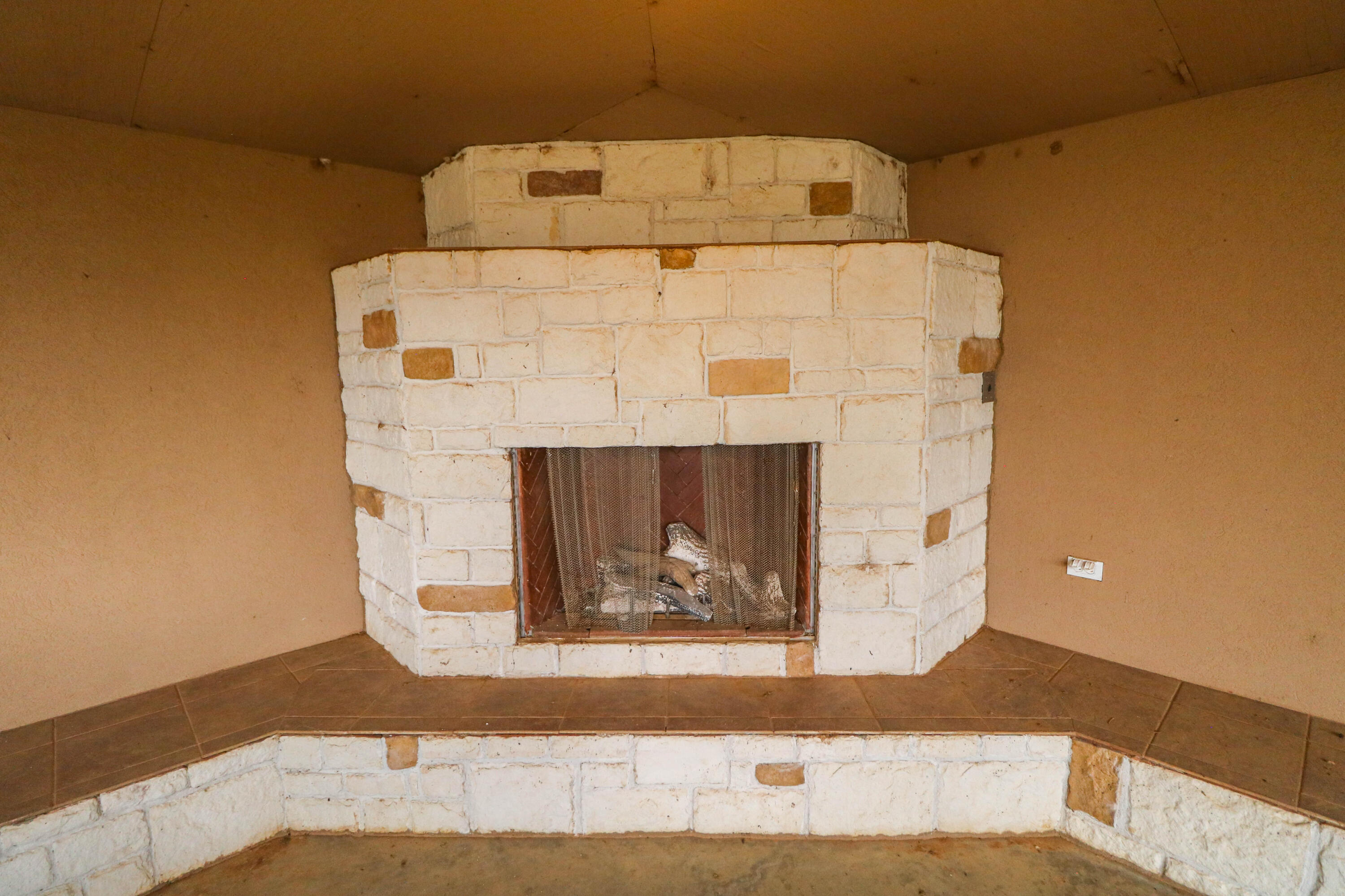 1740 Highway 70 Springlake, TX 79082 - Photo 25 of 39 a close up of a fireplace with wooden floor