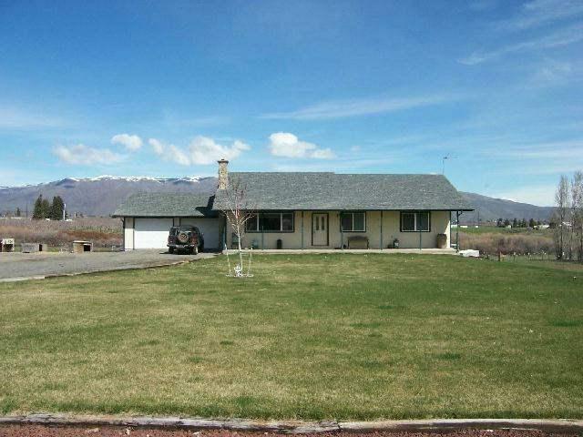 501 Sharp Road Tieton, WA 98947 - Photo 1 of 13 a front view of a house with a garden