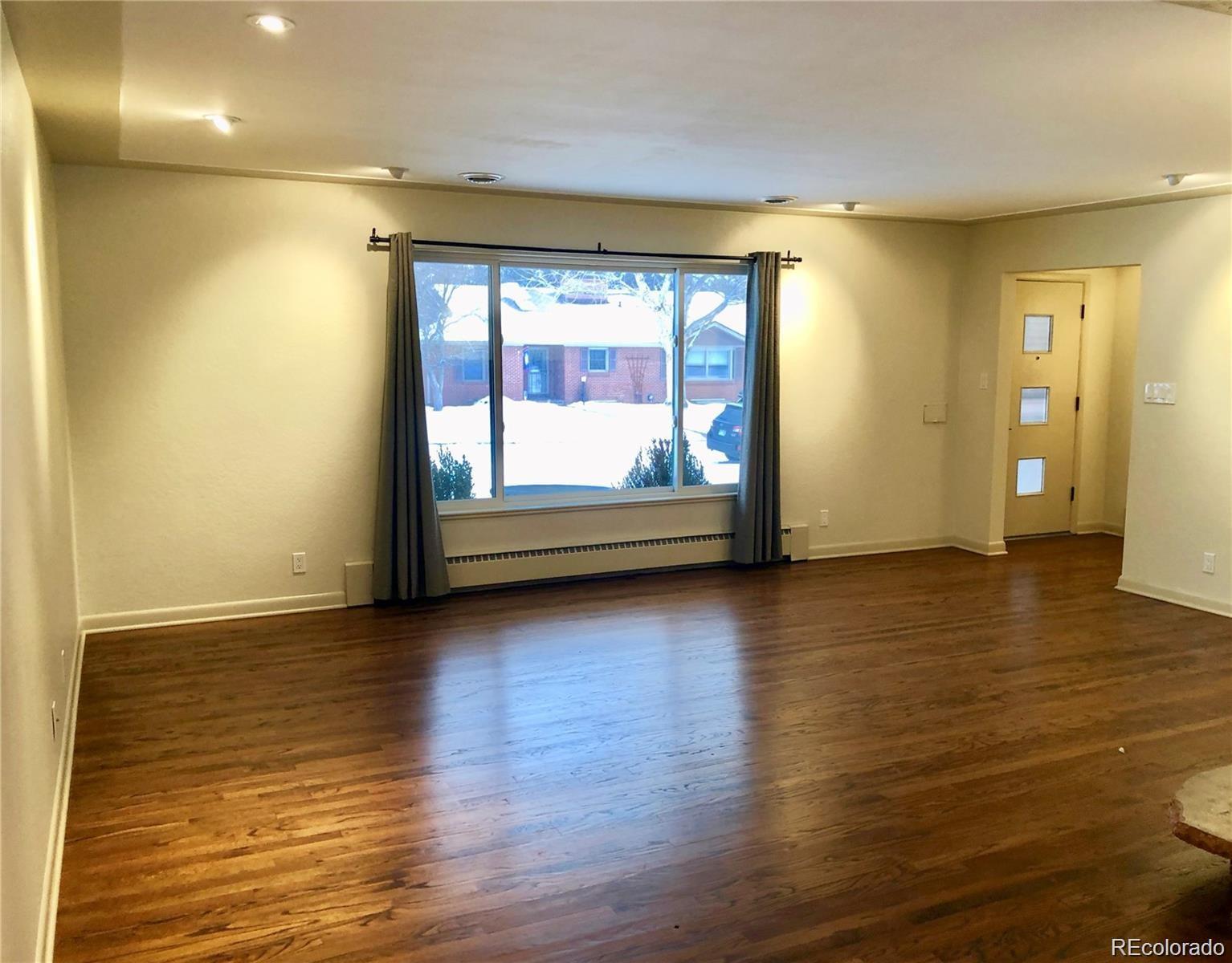 3022 South Gilpin Street Denver, CO 80210 - Photo 13 of 28 a view of room with wooden floor and window