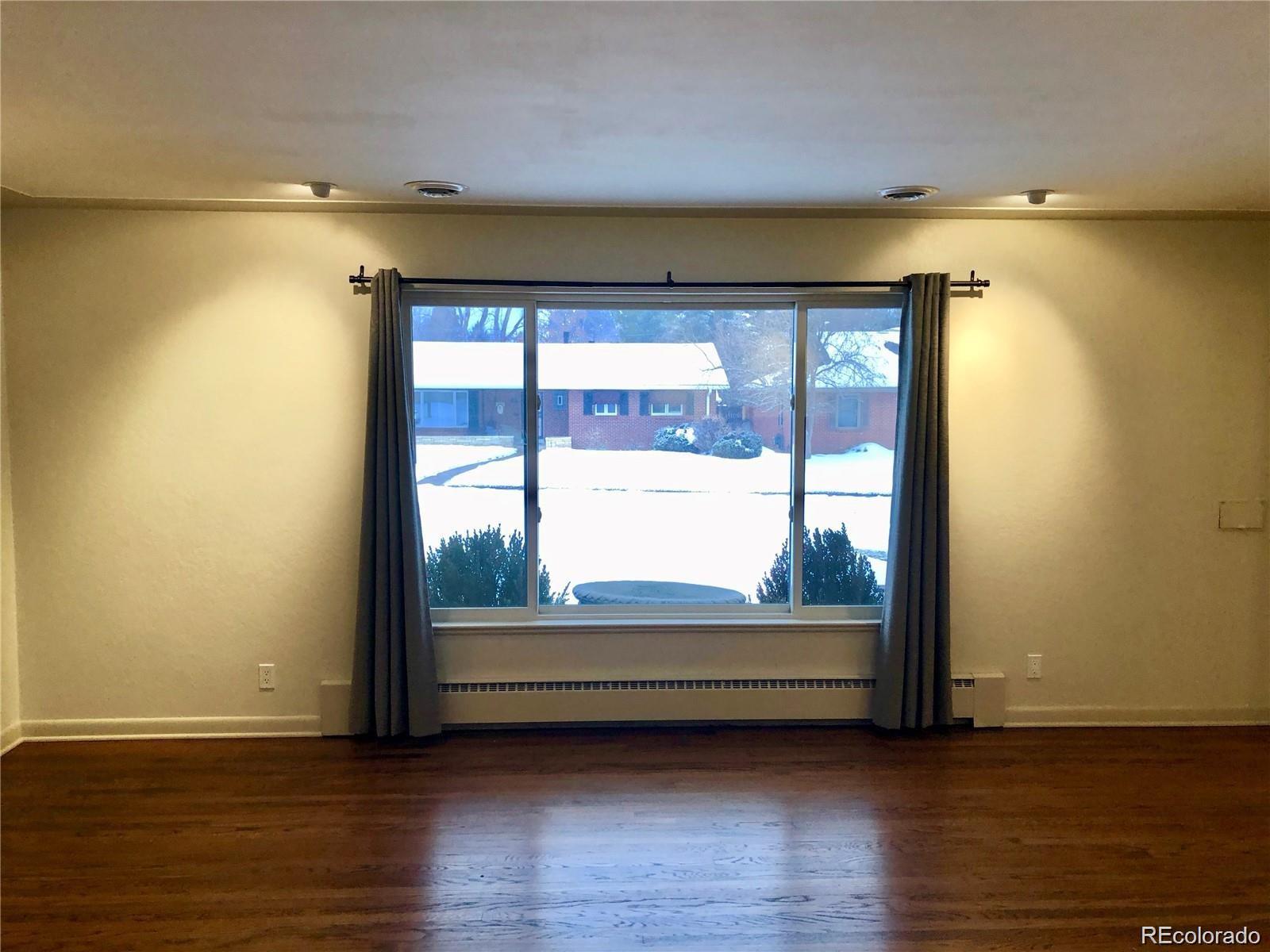 3022 South Gilpin Street Denver, CO 80210 - Photo 14 of 28 a view of room with wooden floor and window