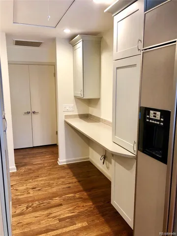 a kitchen with granite countertop a refrigerator and a sink