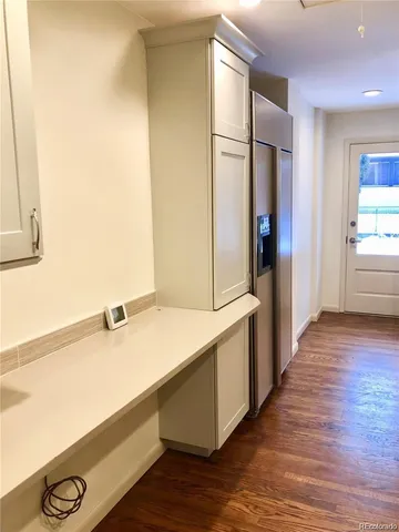 a kitchen with a refrigerator and a sink